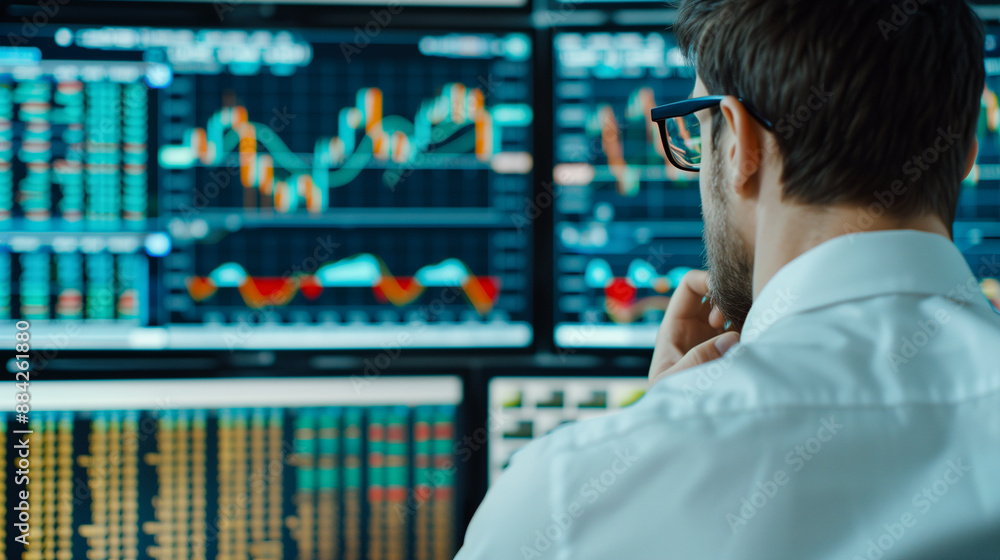 Poster stock trader looking at stocks and shares on computer in a high rise office