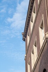 facade of a 100 year old building against a blue sky