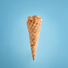 Wafer Ice Cream Cone Against Minimalist Blue Backdrop