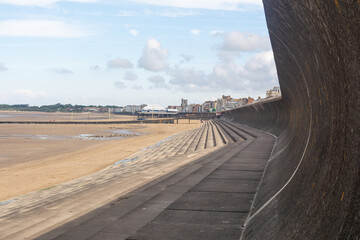 A detailed view of the promenade and wide sandy beach at Burnham-on-Sea, highlighting the unique...