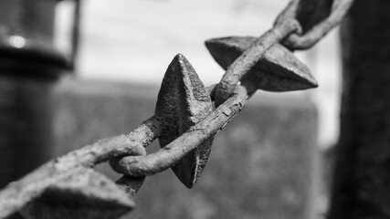 Close-up of a Weathered Metal Chain Link - A detailed black and white image capturing the texture and form of a weathered metal chain link, highlighting its rugged and aged appearance