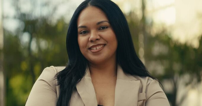 Young business woman walking around the city using her phone and laptop