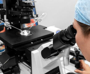 Embryologist adding sperm to egg in laboratory of reproductive clinic. in vitro fertilization, egg freezing. injects one sperm into each egg by microinjection. intracytoplasmic Sperm injection. IMSI
