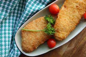 fish with vegetables. Grilled crumbed hake fillets