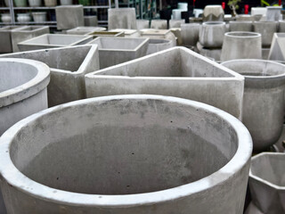Fototapeta premium Several concrete plant pots are stacked on top of each other