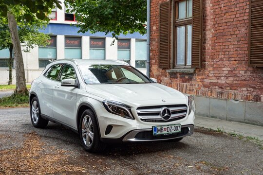 White Mercedes-Benz GLA X156 crossover parked on street