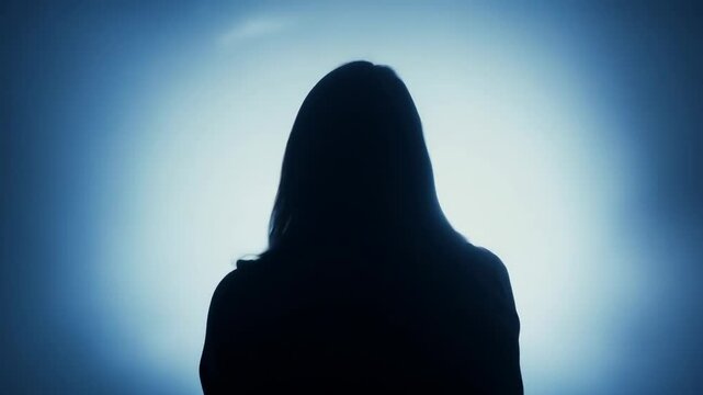 Silhouette of woman blue background with halo effect