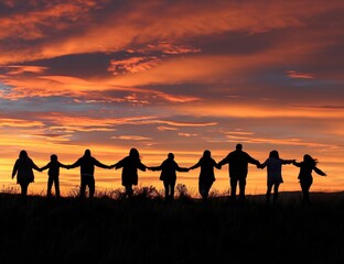 Silhouettes of people holding hands at sunset, symbolizing unity and togetherness. Perfect for themes of community, support, and connection.