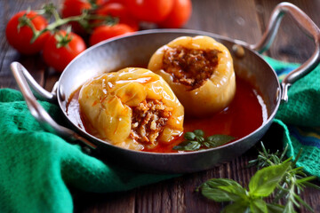 Stuffed peppers with ground meat and rice in tomato sauce
