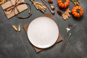 Autumn table setting on a dark background. Top view, flat lay, copy space.