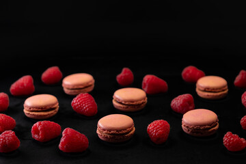 macaroons of different colors on a black background