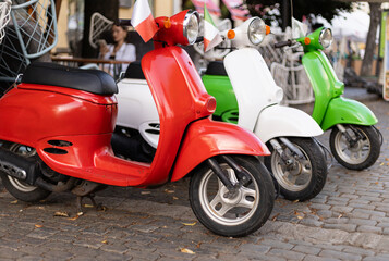 three outdoor mopeds in the colors of the Italian flag © Sabineyro
