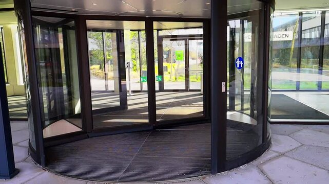 Modern entrance with revolving door. Entrance to a building and glass door. High quality FullHD footage