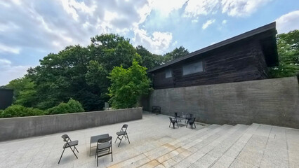 an old house built of wood and a cement fence
