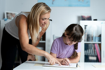 mother helping her daughter with her homework