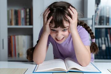 girl with hands on her head bored of studying