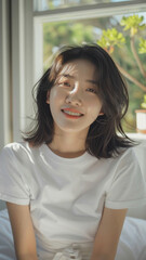 A striking portrait of a young Asian woman wearing an white t-shirt, exuding natural beauty and contemporary style.