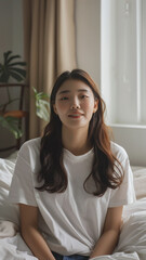 A striking portrait of a young Asian woman wearing an white t-shirt, exuding natural beauty and contemporary style.