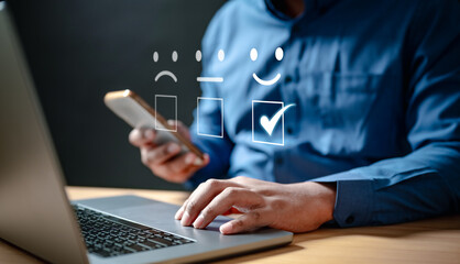 confidential, management, information, social, network, policy, system, office, software, secure. A man is using a laptop with cell phone. cell phone has a thumbs up and a thumbs down sticker on it. © Garun Studios