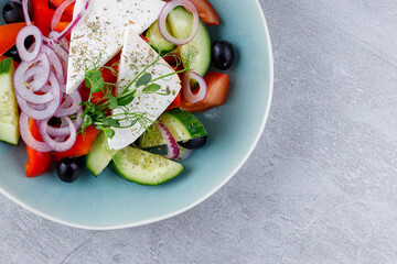 Apetite Greek salad in beautiful dishes for food delivery website menu on gray background.