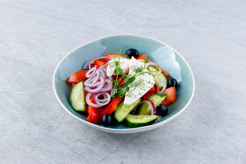 Apetite Greek salad in beautiful dishes for food delivery website menu on gray background.