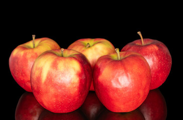 Several red apples, macro, isolated on black background.