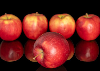 Several red apples, macro, isolated on black background.