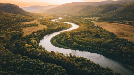 Aerial View of River Winding Through Lush Green Valley.