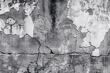 A close-up of an aged wall with cracked and peeling paint giving it a weathered and rustic texture
