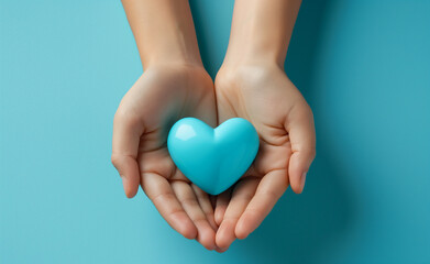 Fototapeta premium Hands holding a glowing blue heart symbolizing love and care.
