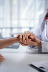Doctor demonstrates empathy and support to a patient in a medical office, highlighting the...