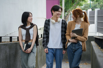 Three college students enjoying a sunny day outdoors, taking a break from classes and socializing