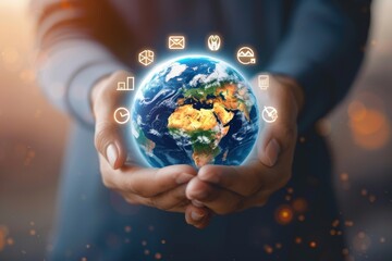 Hand cradling glowing Earth with business icons representing global communication and technology.