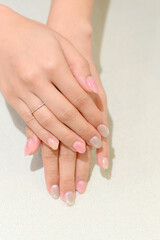 Hands with freshly done glittery manicure, fingers gently crossed, displaying a polished and elegant look.