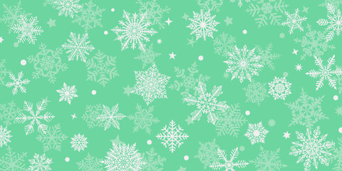 Christmas background of beautiful complex snowflakes, white on light green. Winter illustration with falling snow.