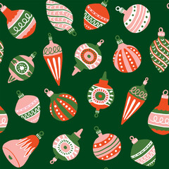 Vintage Christmas tree ornaments in red and pink on green background seamless pattern. Repeat holiday season pattern for wrapping paper, textile design.