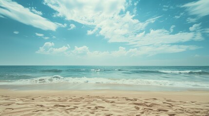 Fototapeta premium Peaceful beach with clear blue sky and gentle waves.
