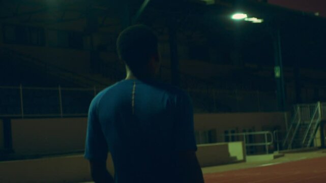 Back shot of a para runner on the track at night