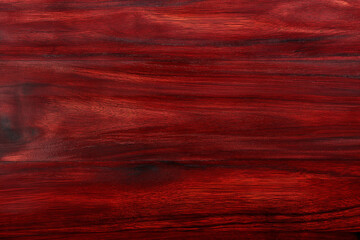 A close up of a red wood grain