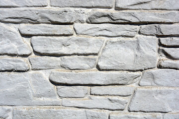 Building materials, gray concrete cement fence made in the form of natural drilled stones.