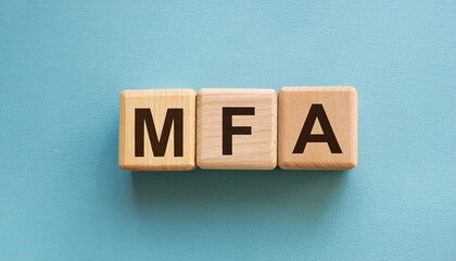 Obraz premium Wooden cubes with abbreviation MFA, blue background. Multi-Factor Authentication. Online security