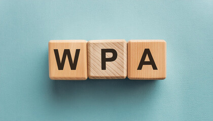 Obraz premium Wooden cubes with abbreviation WPA, blue backdrop. Wi-Fi Protected Access. Internet, online security