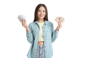 Young Asian woman with piggy bank and money on white background