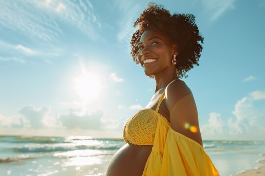 Happy smiling black pregnant woman walking on sea beach, future mother waiting baby, joyful woman pregnant