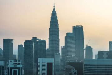 Fototapeta premium Kuala Lumpur city skyline with silhouettes of high-rise buildings and skyscrapers at sunrise, Malaysia. Downtown financial and business center of Asian city with modern architecture