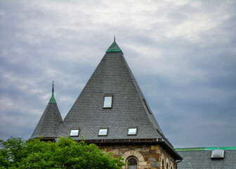 Fototapeta premium High-Pitched Roof of an old building under an overcast sky, Newton, Massachusetts, USA