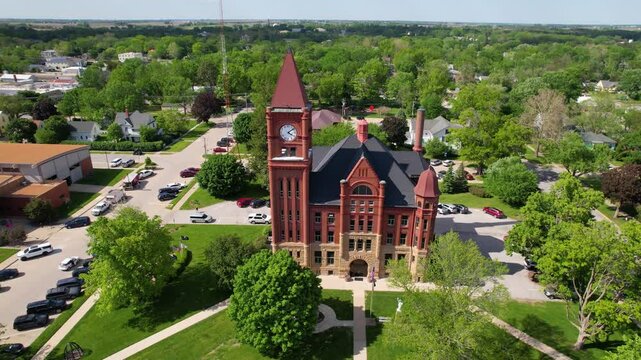 IOWA - 6.24.2024 - Excellent aerial view circling an old courthouse with a clock tower in Fairfield, Iowa.