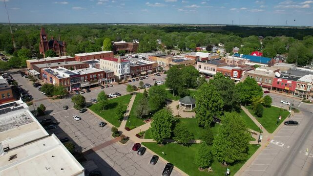 IOWA - 6.24.2024 - Excellent aerial view moving over a public park with a gazebo in Fairfield, Iowa.