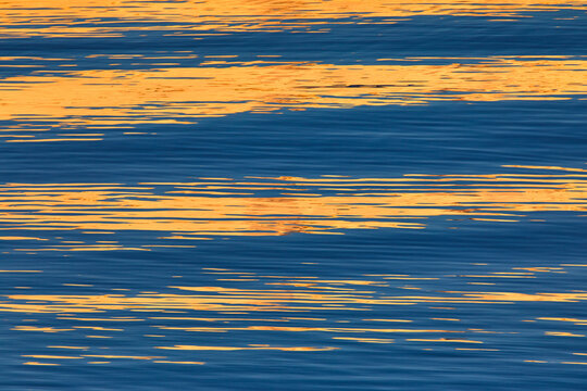 Rippled water reflection at sunset in Lofoten, Norway
