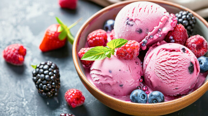 Bowl of berry ice cream with fresh berries and mint. Refreshing and seasonal